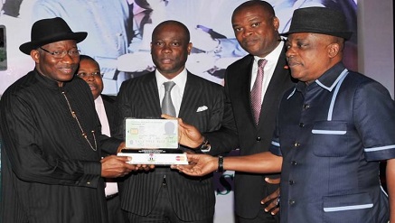 President Goodluck Jonathan flanked by guests at the unveiling of National smart Identity card in Abuja on Thursday.